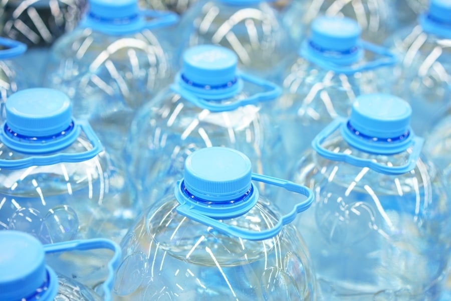 primer-plano-botellas-agua-potable-plastico-cinco-litros-enfoque-suave
