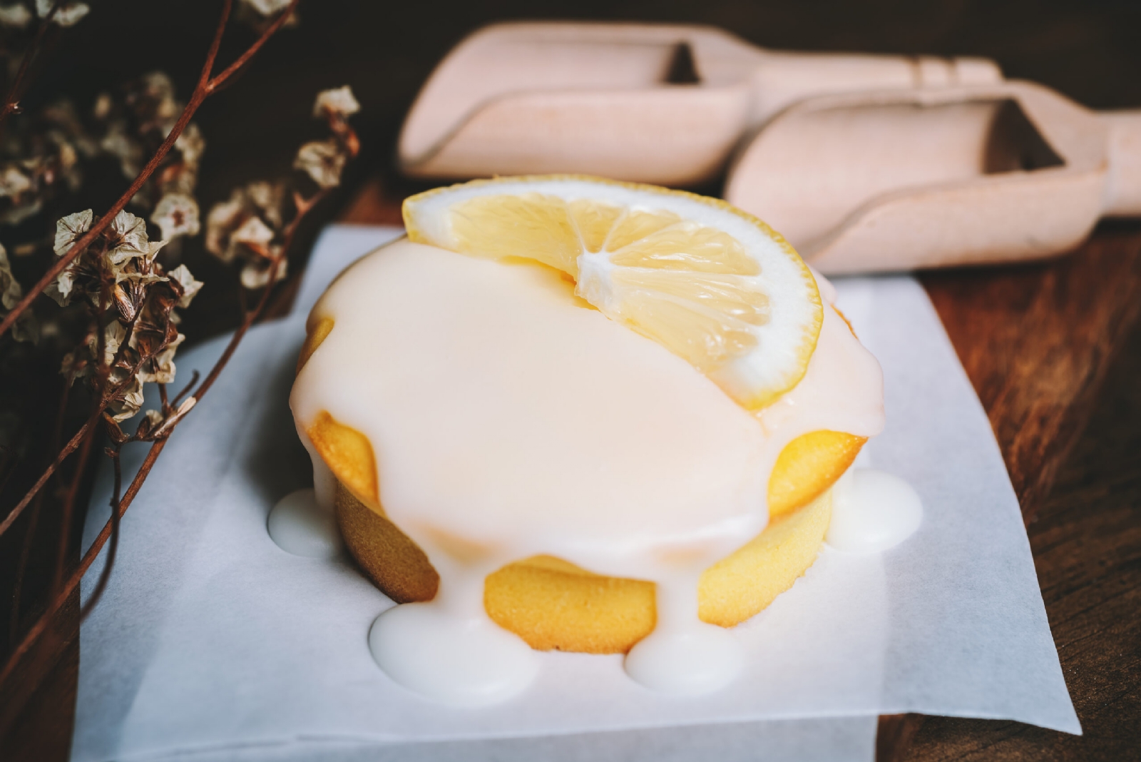 lemon-cake-icing-glaze-cupcake-on-the-table-scaled