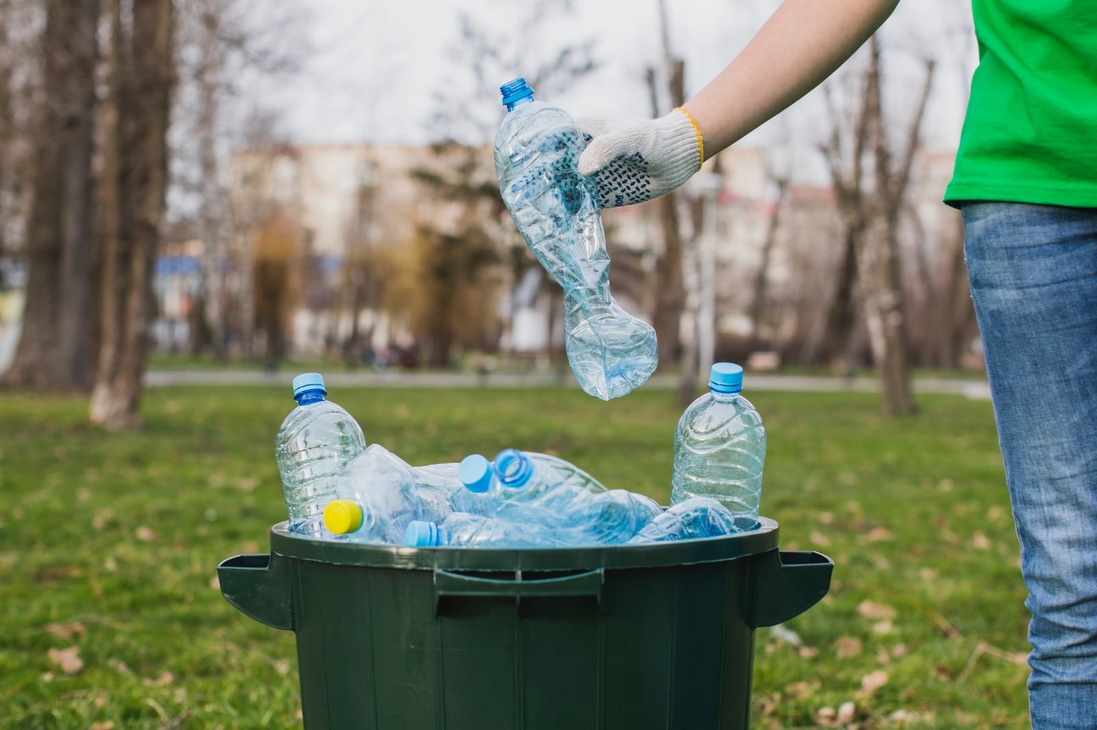 volunteer-putting-plastic-bottles-bin