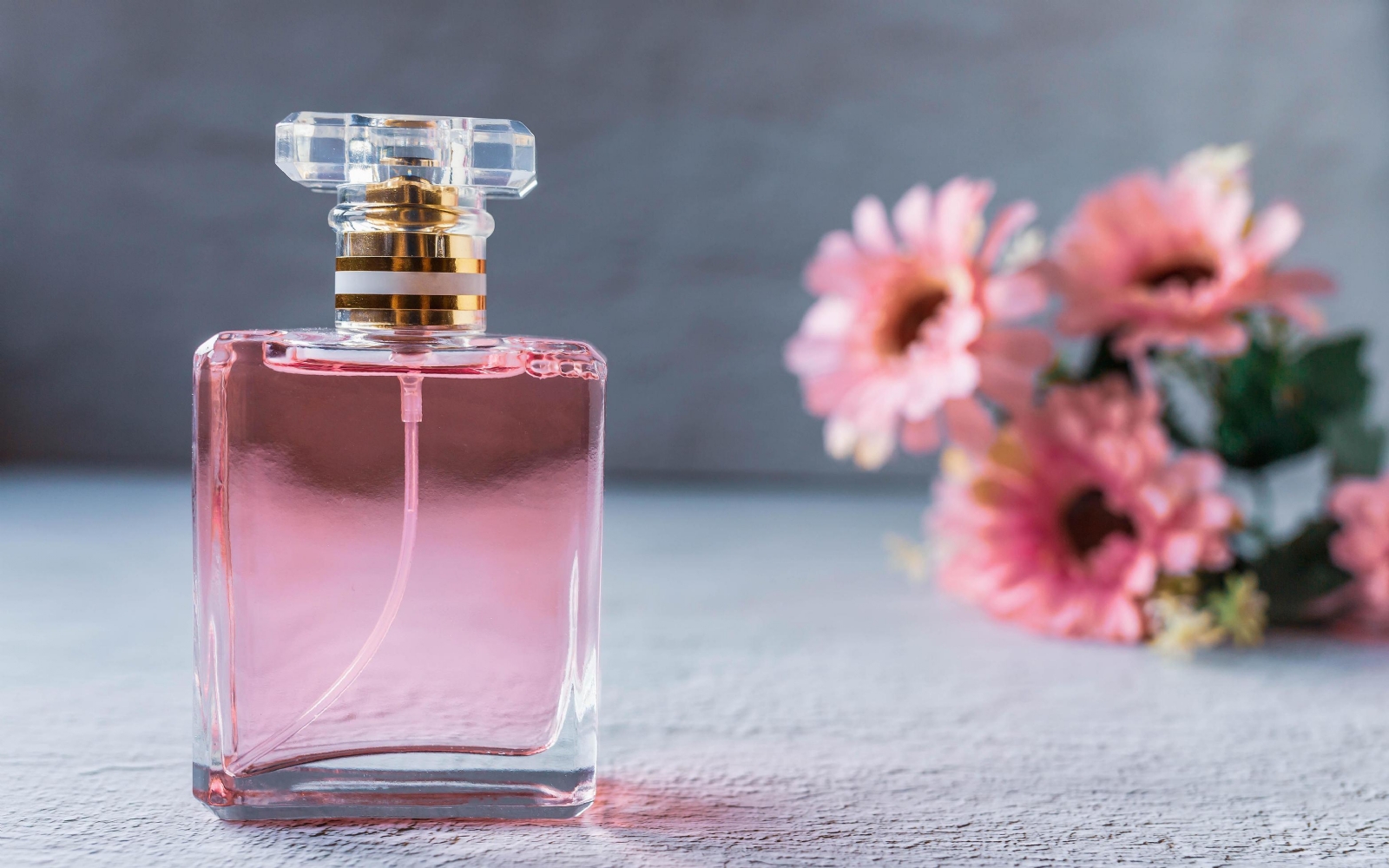 pink-perfume-bottle-with-pink-flowers-free-photo