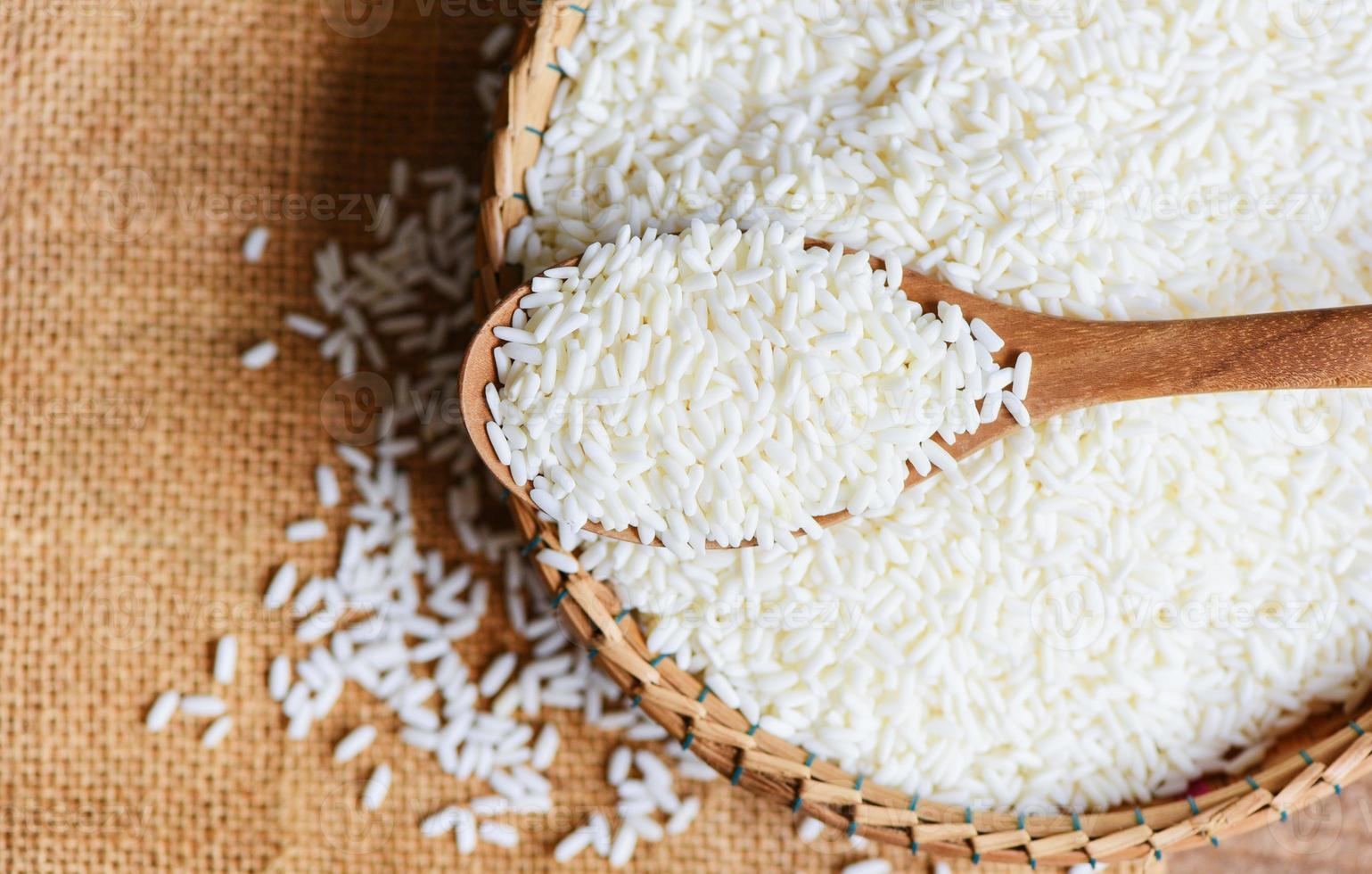 jasmine-white-rice-on-wooden-spoon-on-the-basket-in-the-the-sack-harvest-rice-and-food-grains-cooking-concept-photo